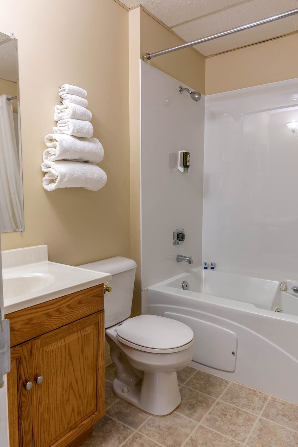 Bathroom with folded towels on the wall